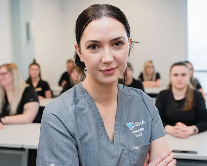 esthetics instructor in front of classroom